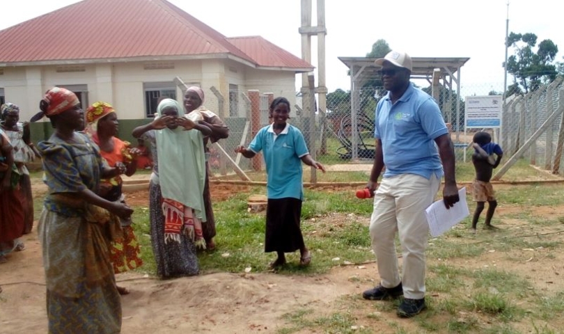Country Director of Life Water International, Mr. Curuma Emmanuel dancing with community members